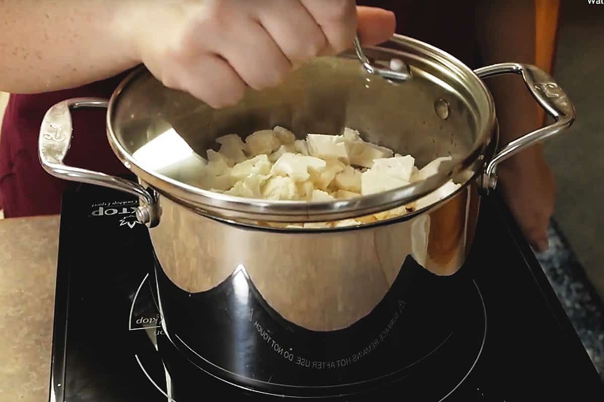 Putting the lid in a pot of cauliflower
