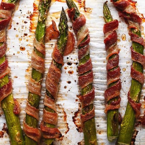 crispy bacon wrapped asparagus on parchment paper