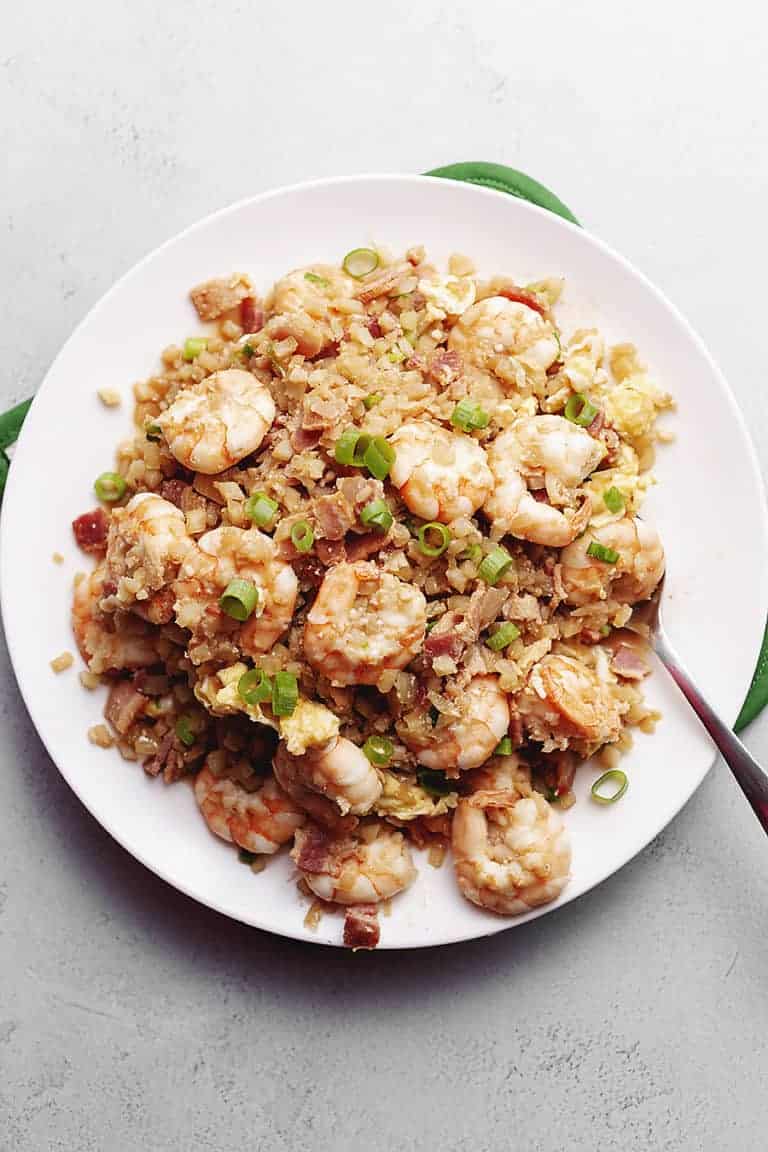 cauliflower fried rice with shrimp on a white plate