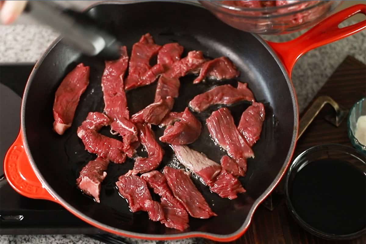 cooking steak in a skillet