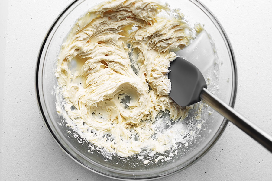 keto buttercream frosting ingredients mixed in a glass bowl