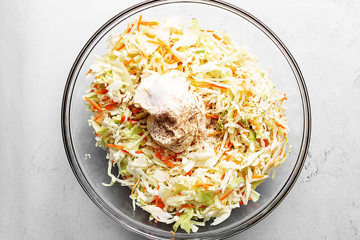 all coleslaw ingredients in a glass bowl