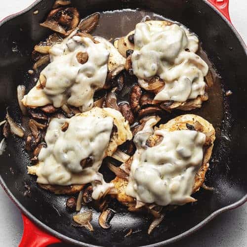 French onion smothered chicken in a cast iron skillet