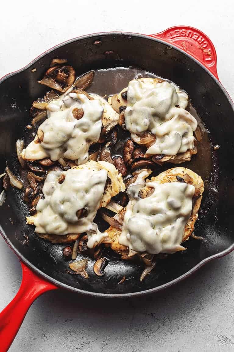 French onion smothered chicken in a cast iron skillet