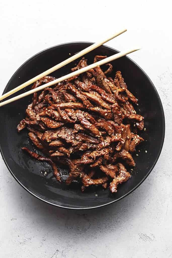 keto beef bulgogi in a black bowl with chopsticks