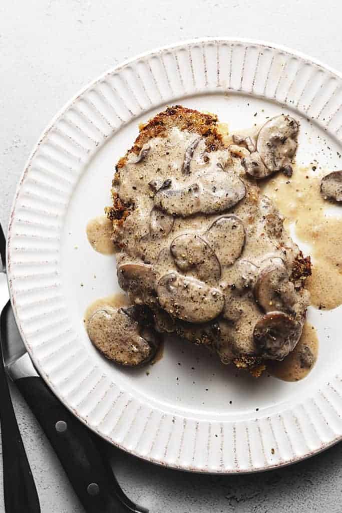 keto chicken fried steak with mushroom gravy on a white plate