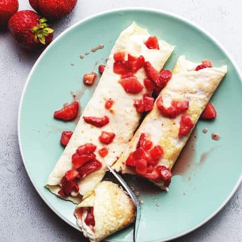 strawberry cream cheese crepes on a plate