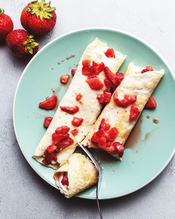 strawberry cream cheese crepes on a plate