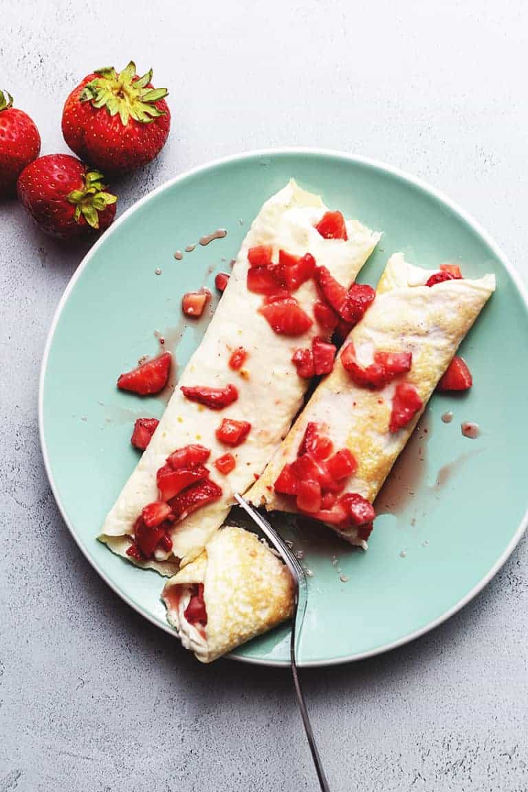 strawberry cream cheese crepes on a plate