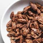 keto candied pecans in a white glass bowl