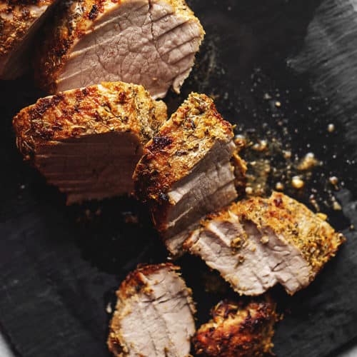 air fryer pork tenderloin cut on a black board