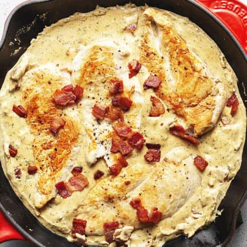 cream cheese chicken with bacon in a red skillet