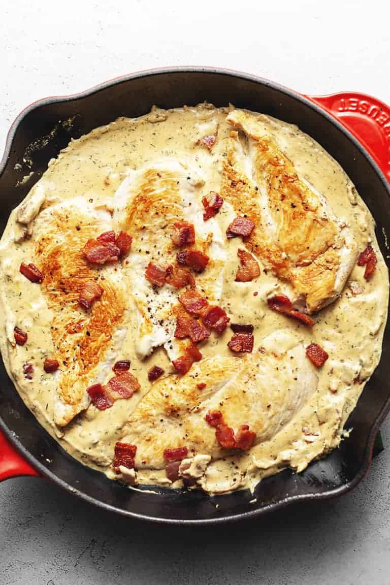 cream cheese chicken with bacon in a red skillet
