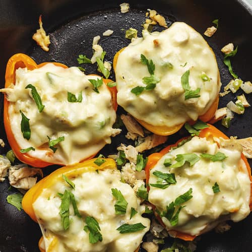 4 stuffed peppers with white cheese in a skillet