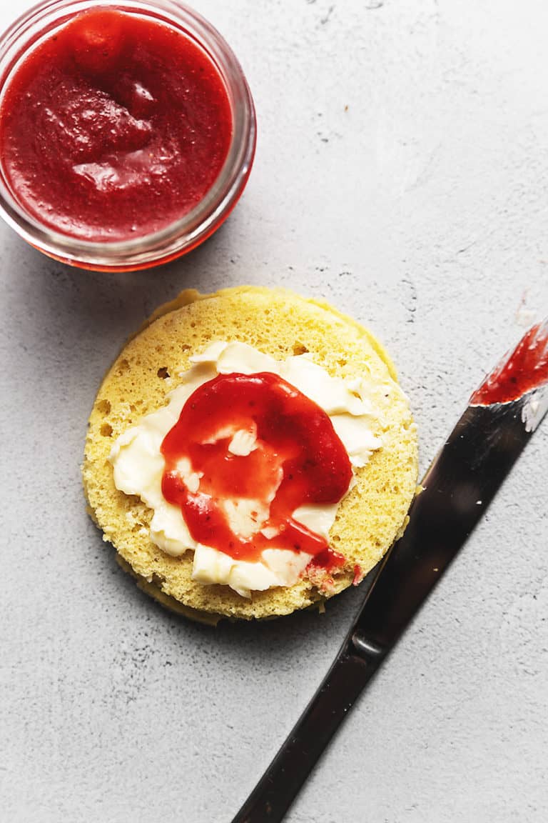 strawberry jam spread on bread with a butter knife