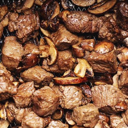 steak cubes and mushrooms in an air fryer