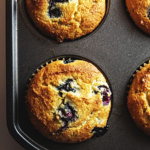 keto blueberry muffins in a muffin tin