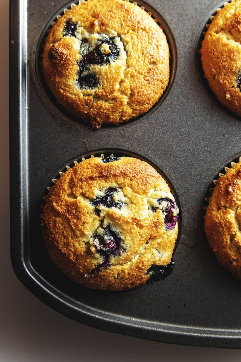 keto blueberry muffins in a muffin tin