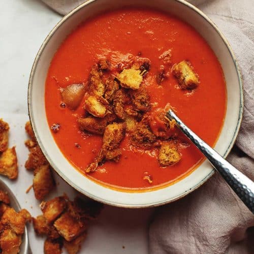 low carb creamy tomato soup with croutons in a bowl