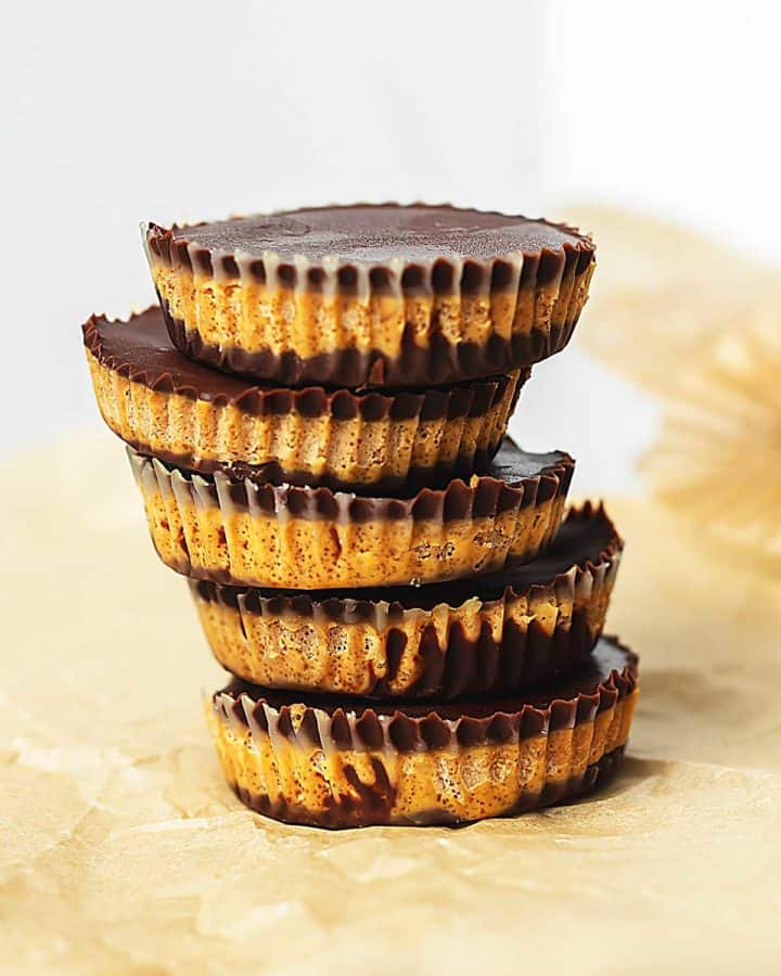 keto peanut butter cups stacked on parchment paper