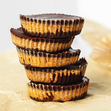 homemade peanut butter cups stacked in parchment paper