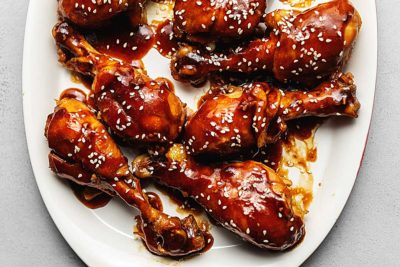 sauced chicken legs on a white plate