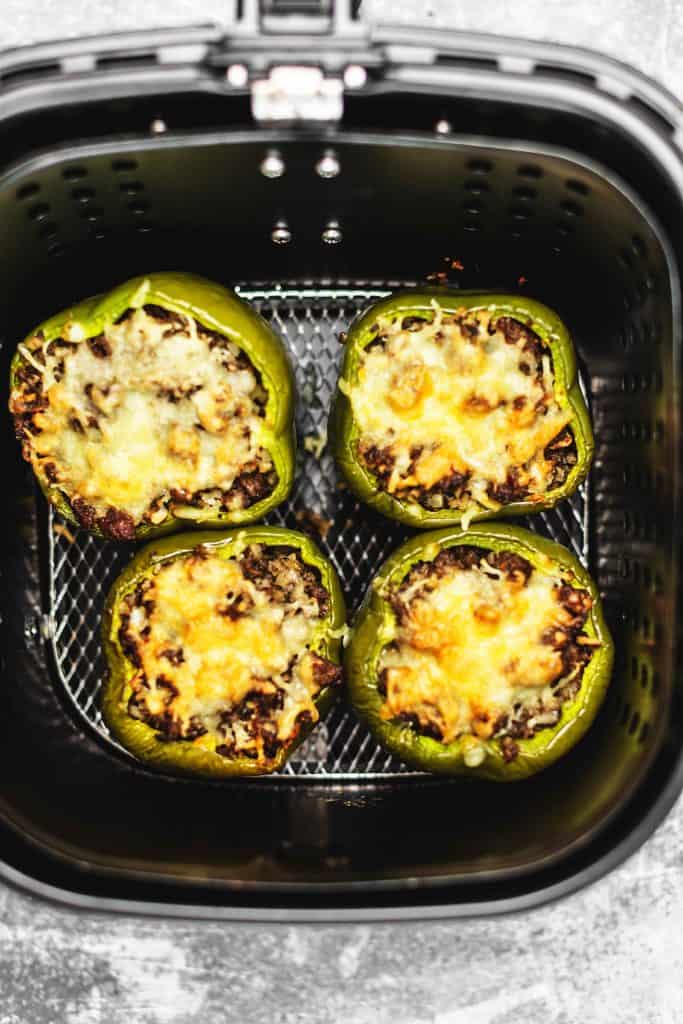 air fryer stuffed peppers being cooked