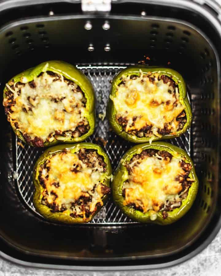 air fryer stuffed peppers being cooked