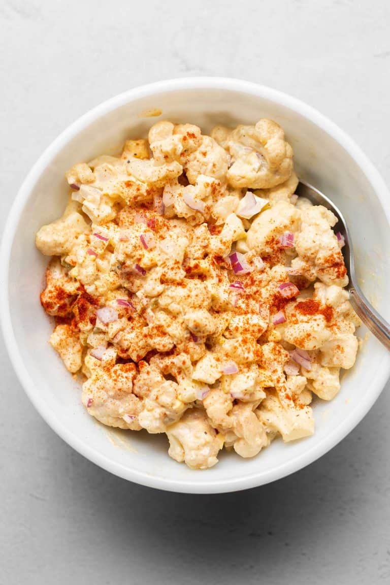 cauliflower potato salad in a white bowl