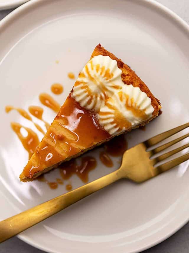 pumpkin cheesecake drizzled with caramel on a white plate