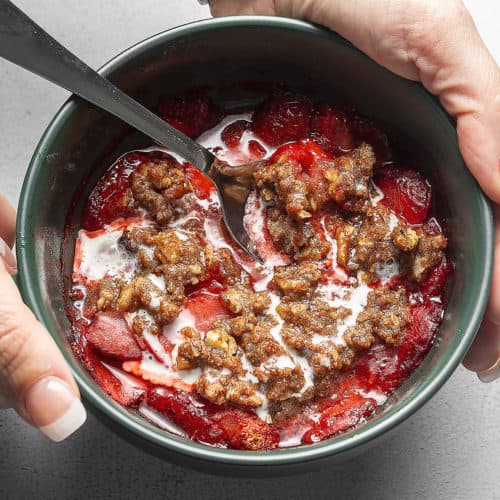 strawberry crisp in a green bowl