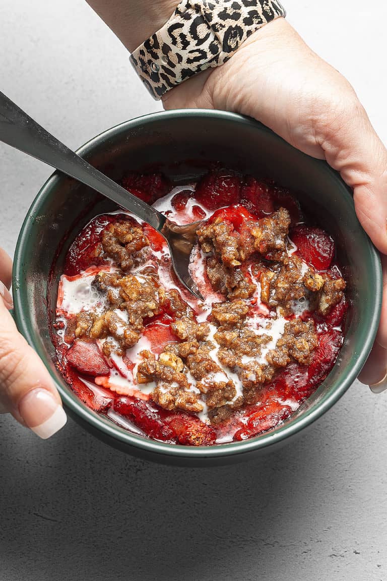 strawberry crisp in a green bowl