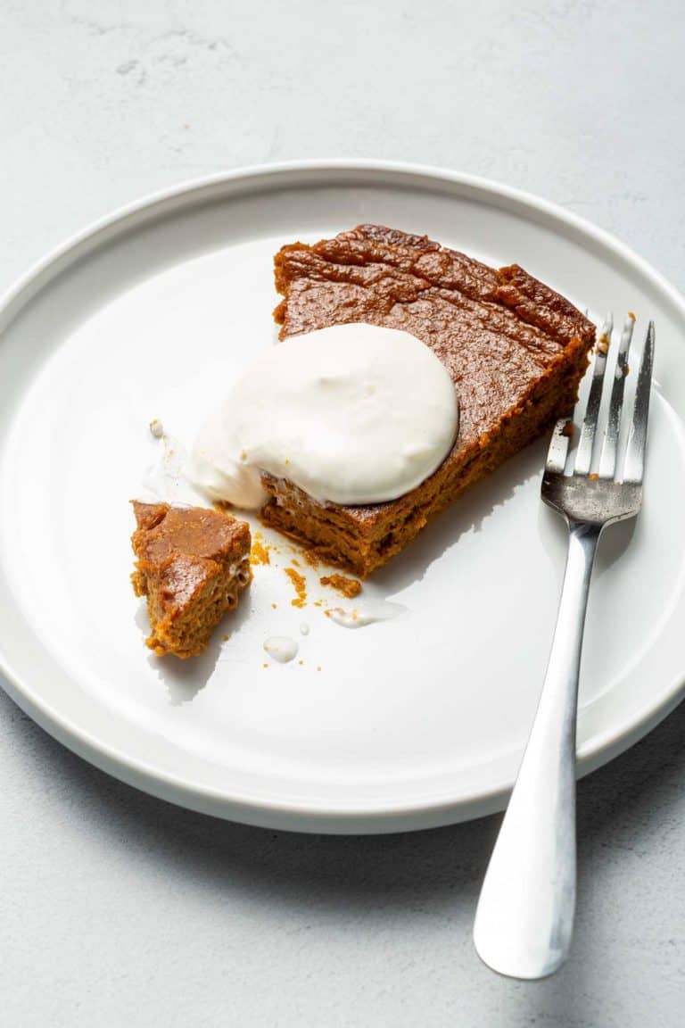 PUMPKIN PIE ON A WHITE PLATE