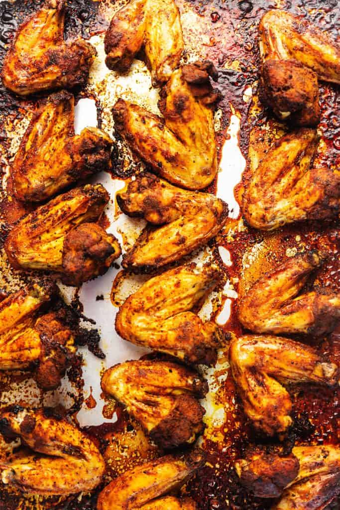 dry rubbed chicken wings cooked on a sheet tray