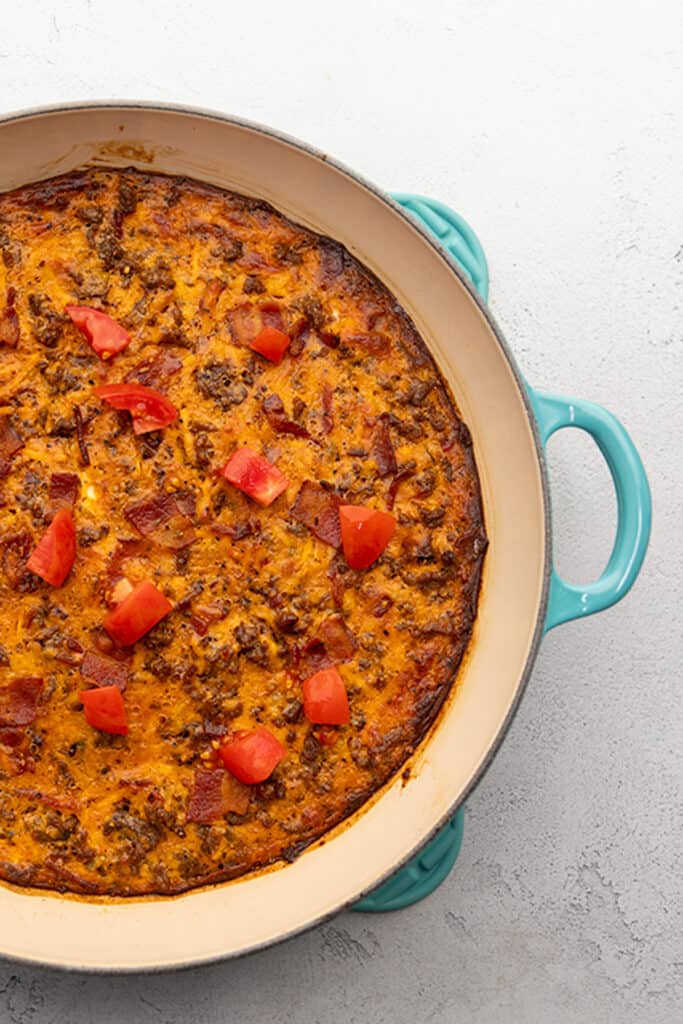 a blue skillet filled with cheeseburger casserole