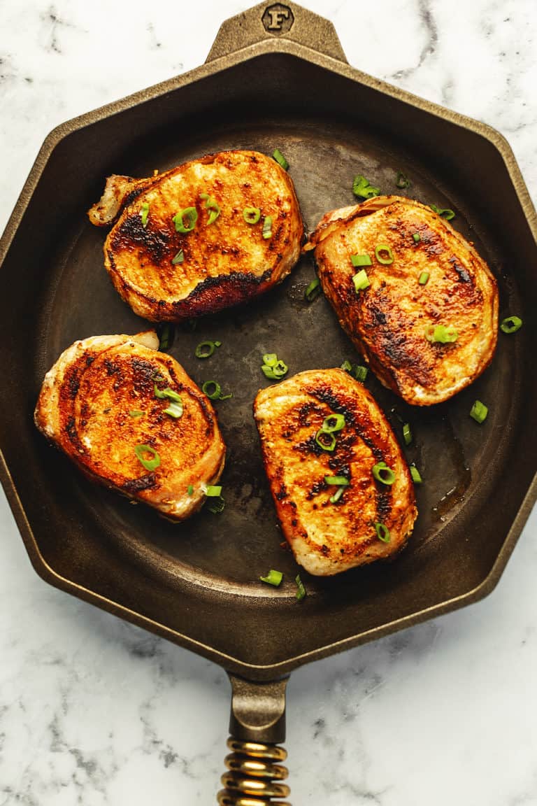 bacon wrapped pork chops in a skillet