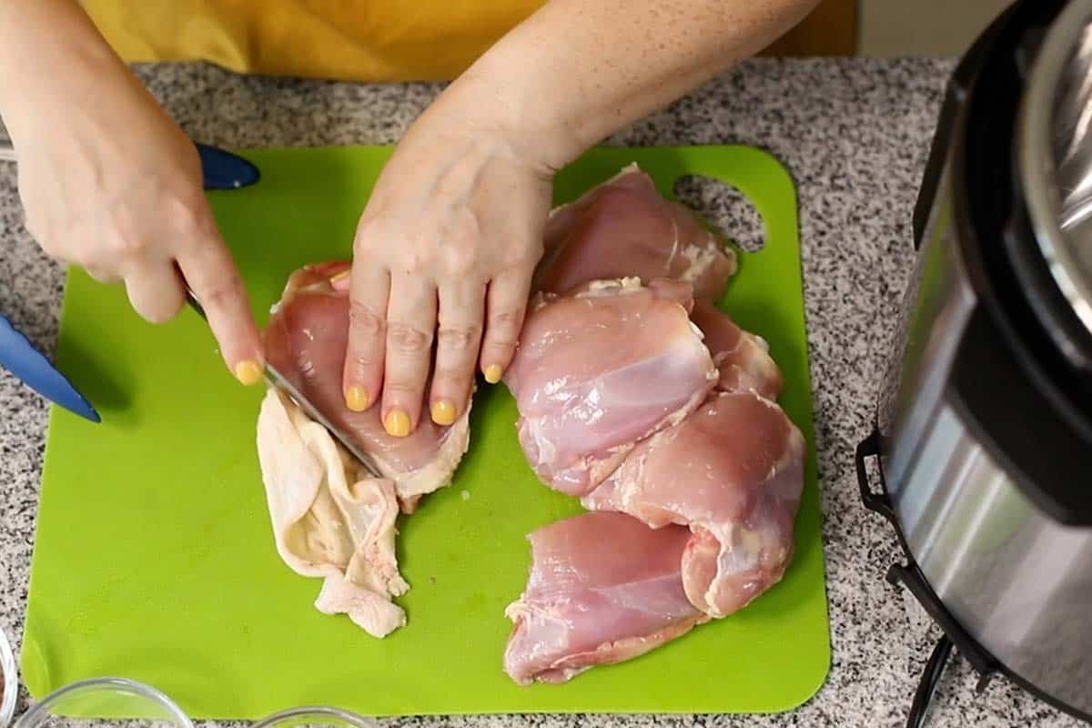 trimming skin from chicken thighs