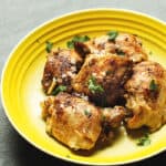 pressure cooker chicken thighs in a yellow bowl