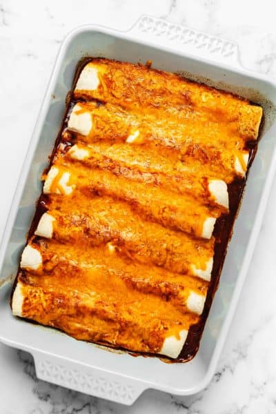 chicken enchiladas with sauce and cheese