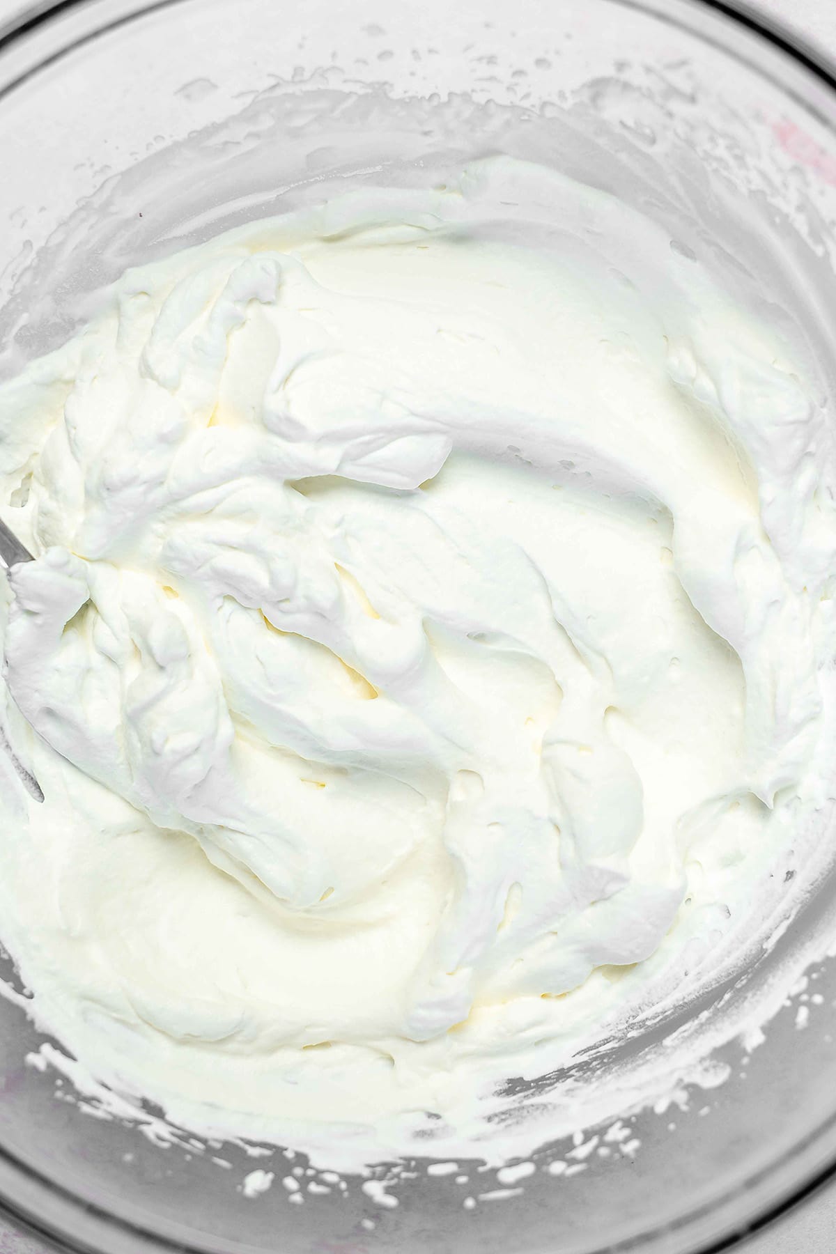a glass bowl full of keto whipped cream
