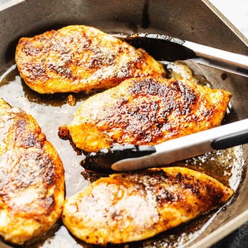 chicken breast cooked in a cast iron skillet