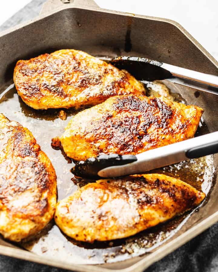 chicken breast cooked in a cast iron skillet