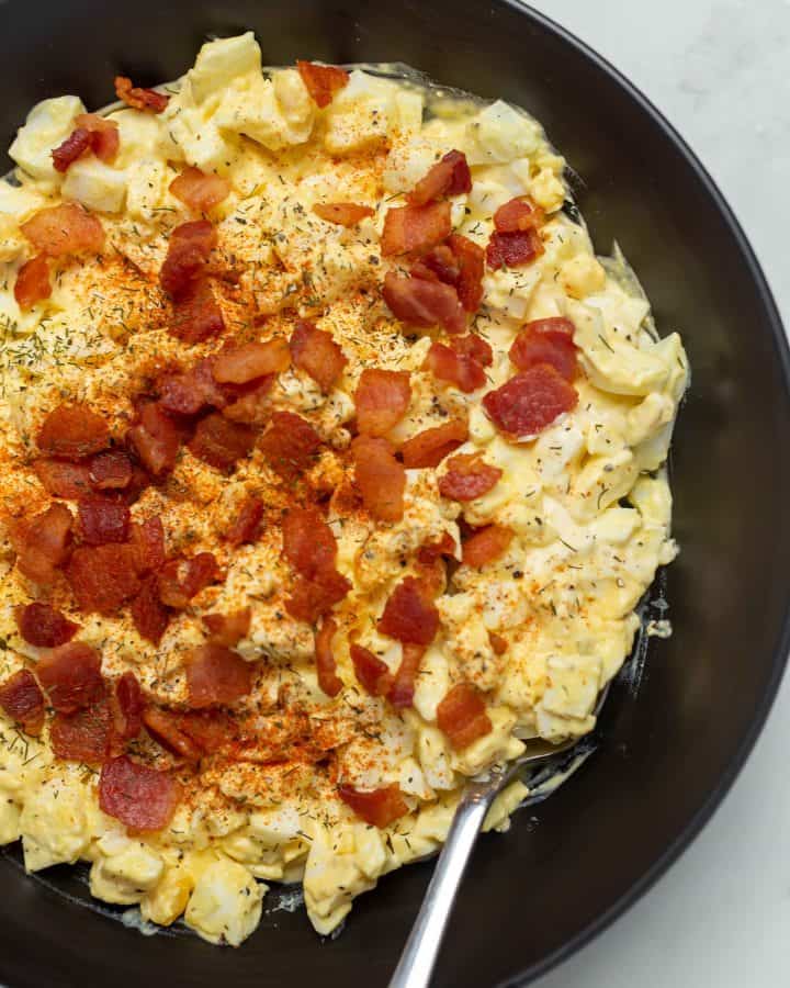 keto egg salad with bacon in a black bowl