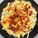 egg salad with bacon in a black bowl