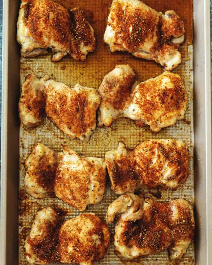 baked boneless skinless chicken thighs on a sheet tray