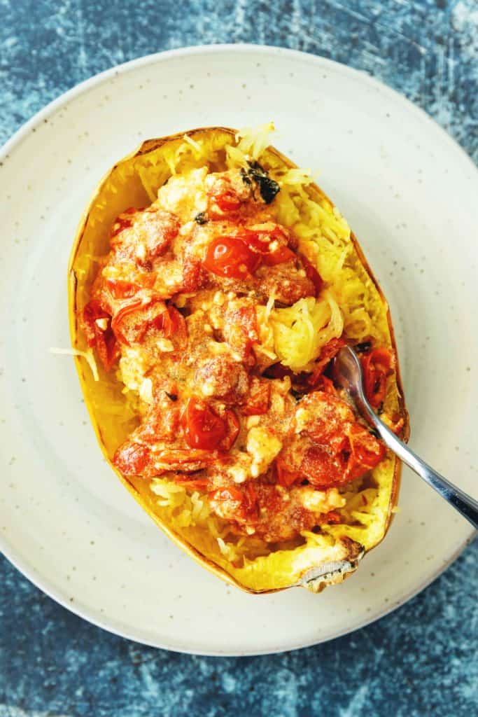baked feta pasta on in spaghetti squash on a white plate