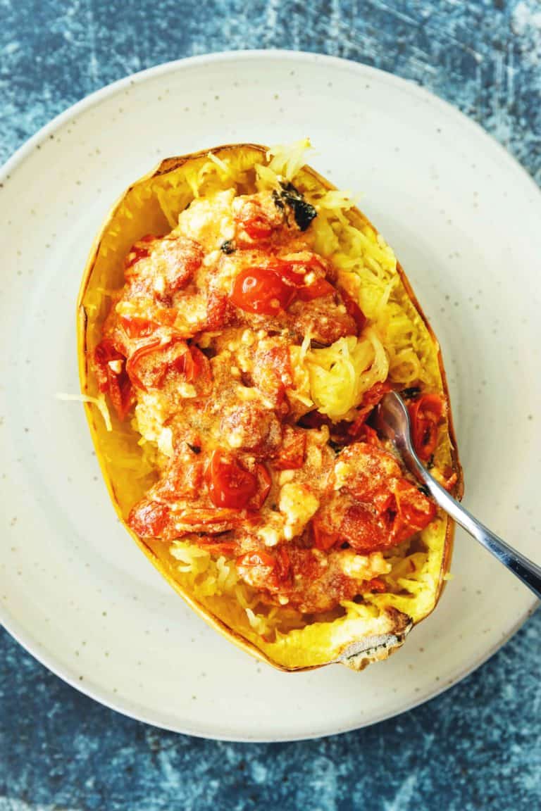 baked feta pasta on in spaghetti squash on a white plate