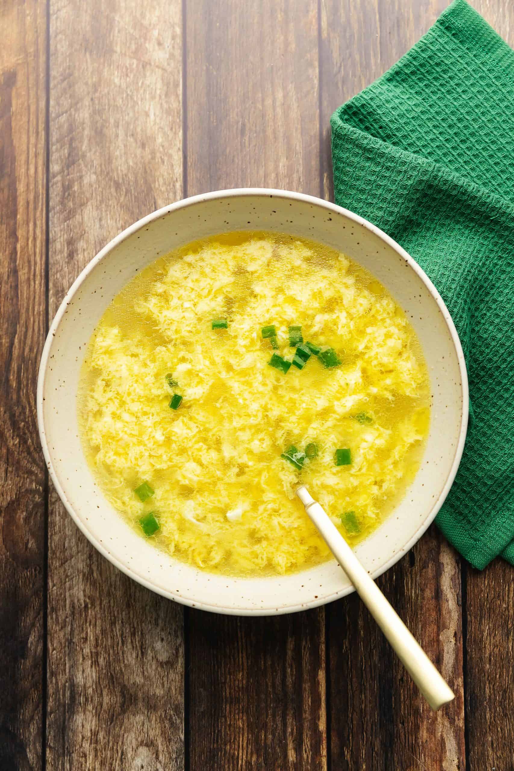 keto egg drop soup in a bowl with scallions