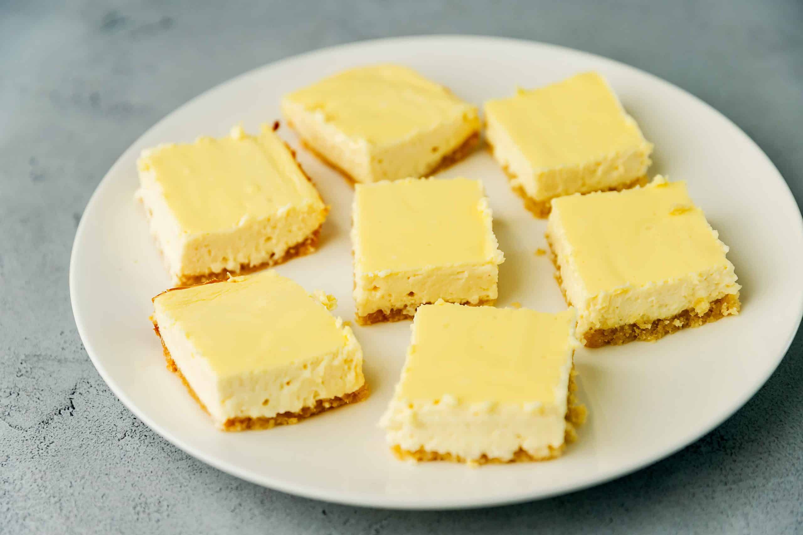 cheesecake bars on a white plate