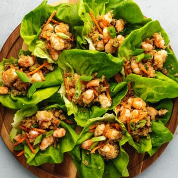 shrimp and cauliflower lettuce wraps on a wood platter